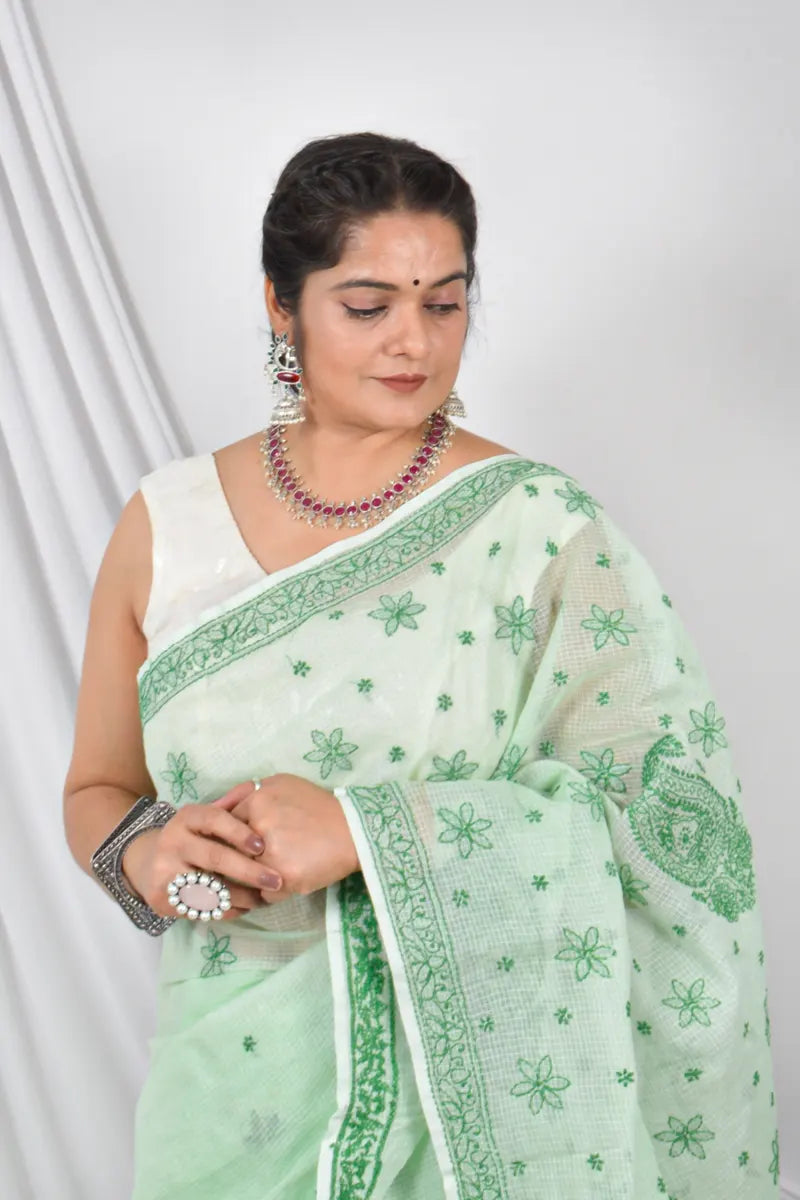 Handcrafted Green Kota Cotton Designer saree with intricate Lucknowi Chikankari embroidery and a matching blouse, ideal for festive and wedding occasions.