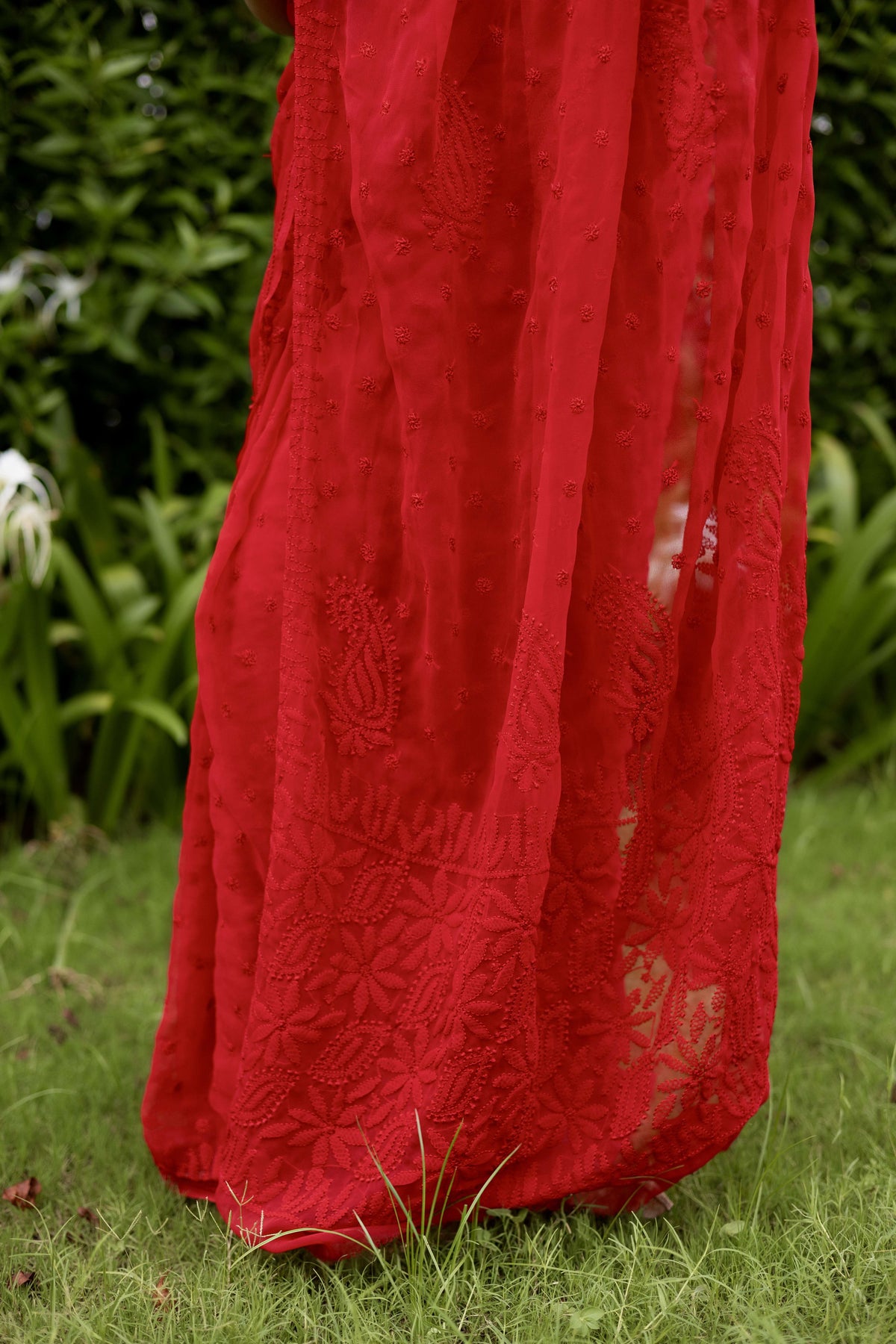 Allover Lucknowi chikankari floral embroidery pattern on red georgette saree pallu