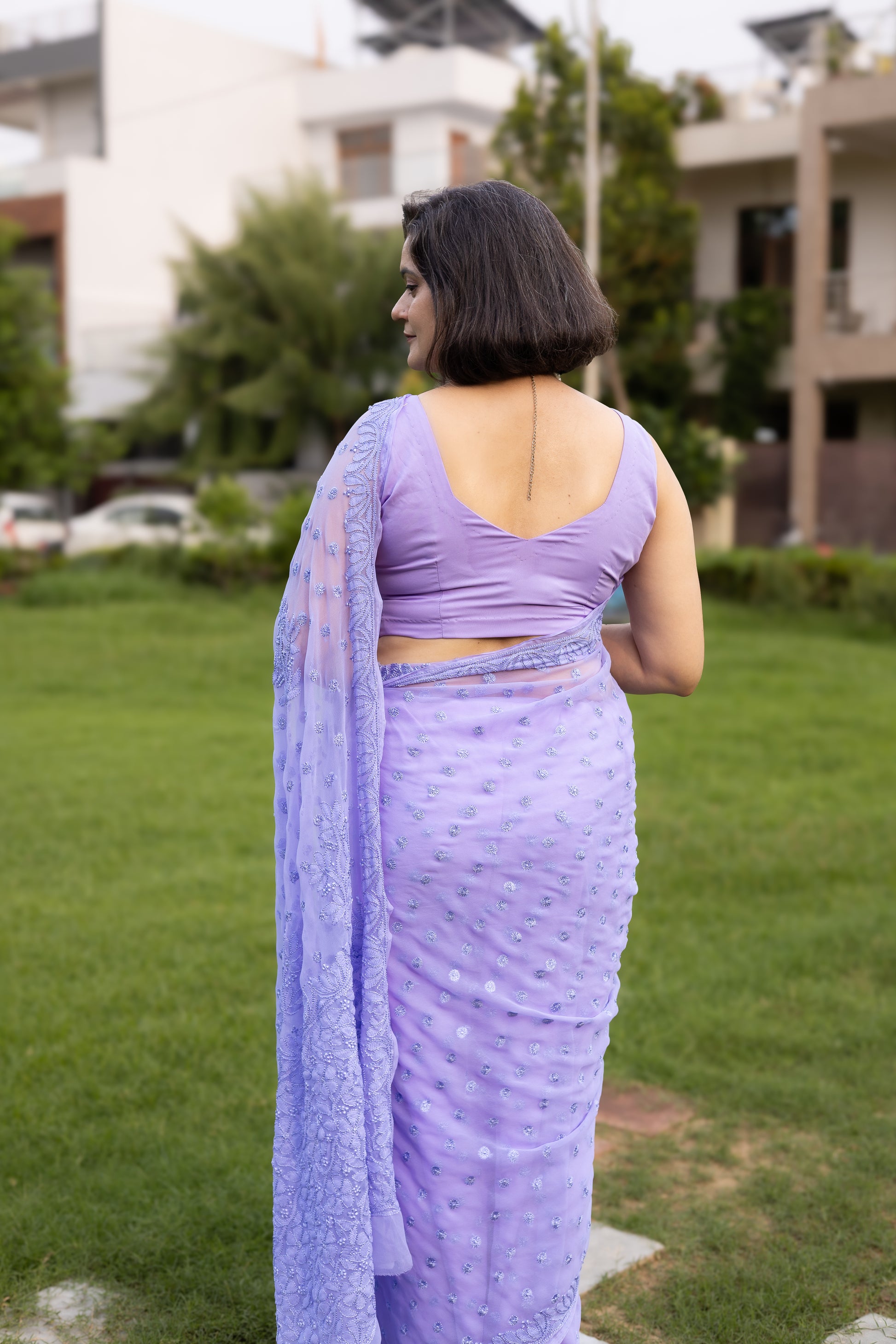 Back view of lavender georgette chikankari saree with matching sleeveless blouse