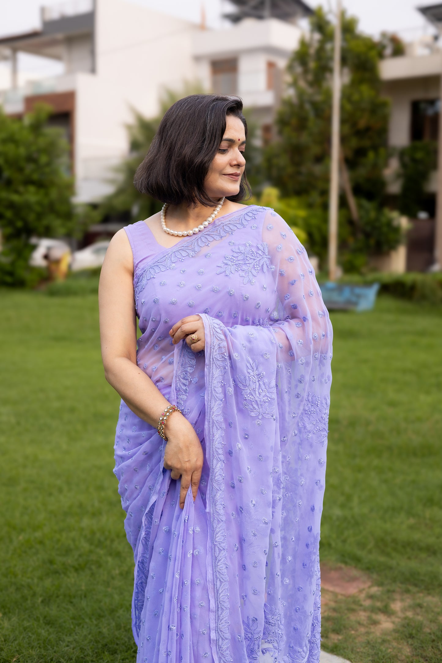 Front view of woman in lavender georgette Lucknowi chikankari saree with blouse